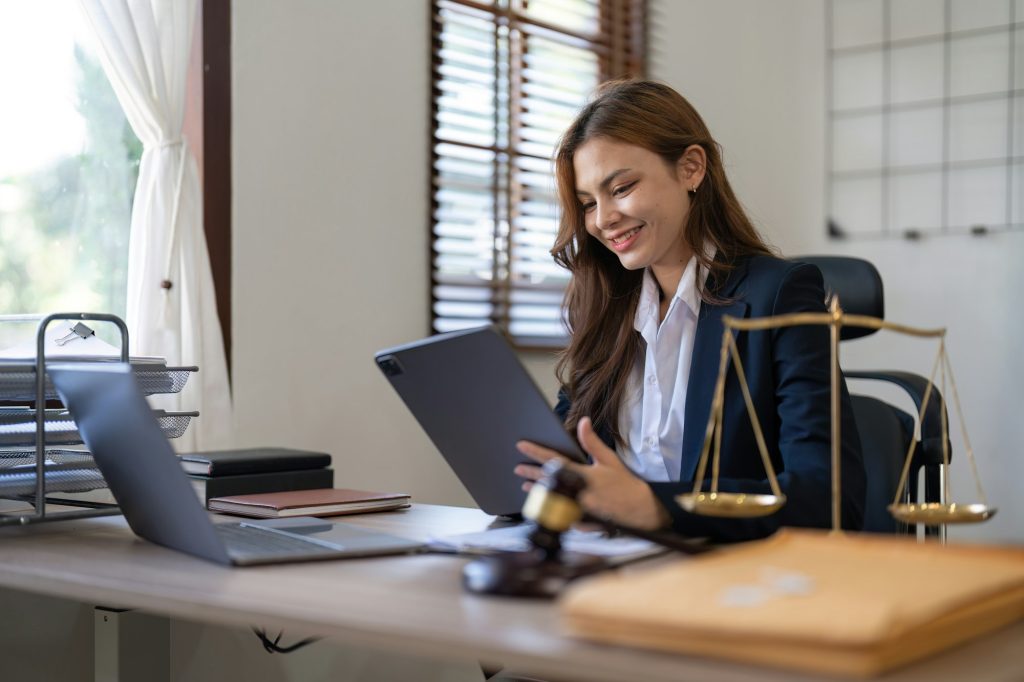 attractive young lawyer in office business woman and lawyers discussing contract papers with brass