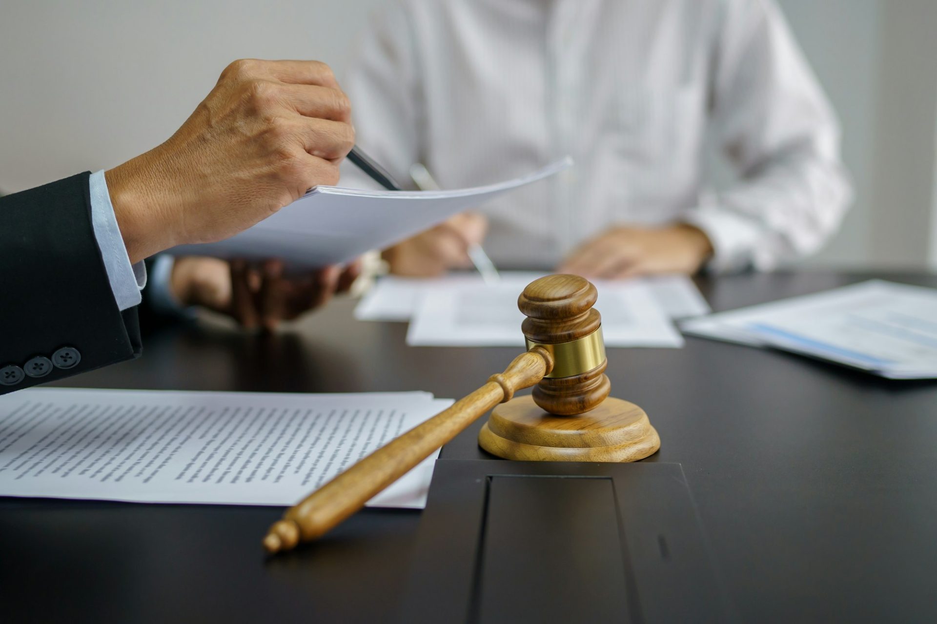 legal counsel presents to the client a signed contract with gavel and legal law
